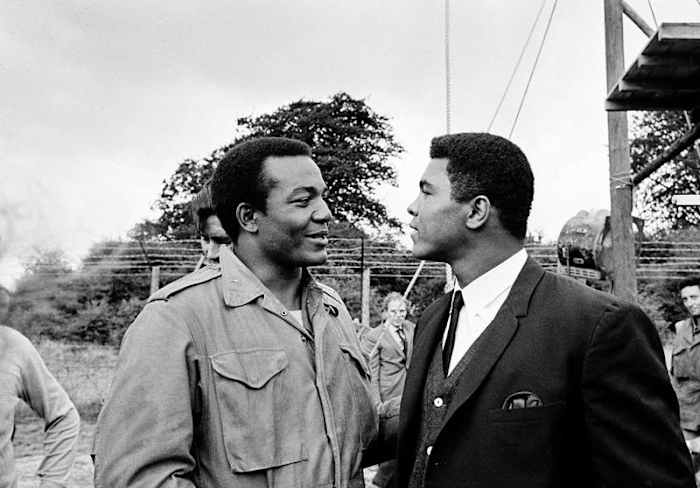 Brown (l.) got a visit from Muhammad Ali while filming in England. (AP Photo)